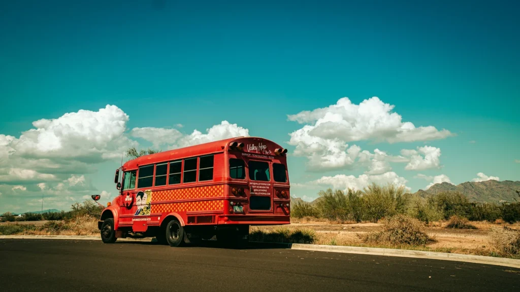 red party bus on the road